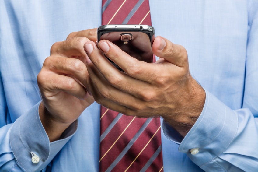 cropped image of businessman on smart phone