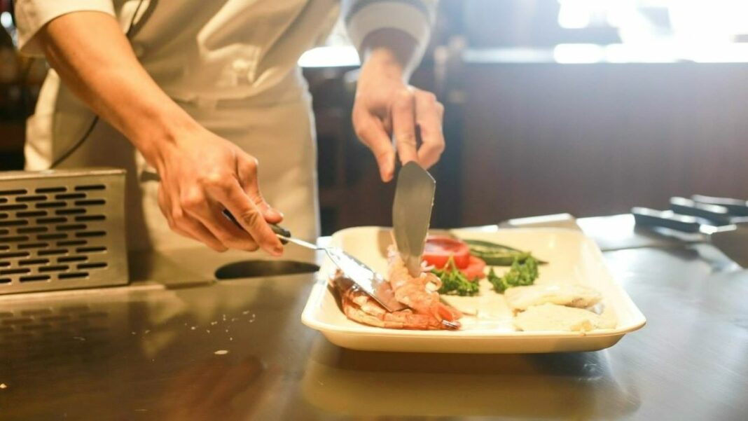 restaurant labor costs represented by chef preparing a meal