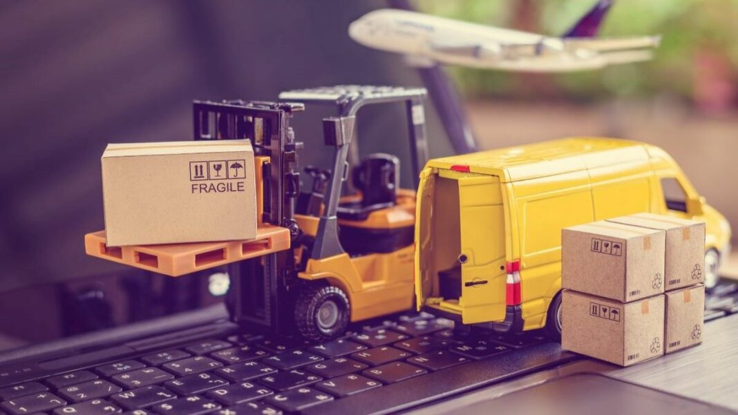 B2B marketing represented by model forklift, delivery truck, and boxes sitting on a laptop keyboard