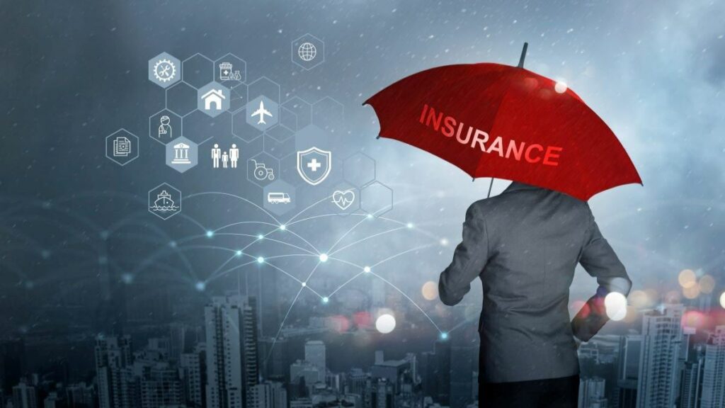 business insurance represented by an individual holding a red umbrella emblazoned with the word "insurance"