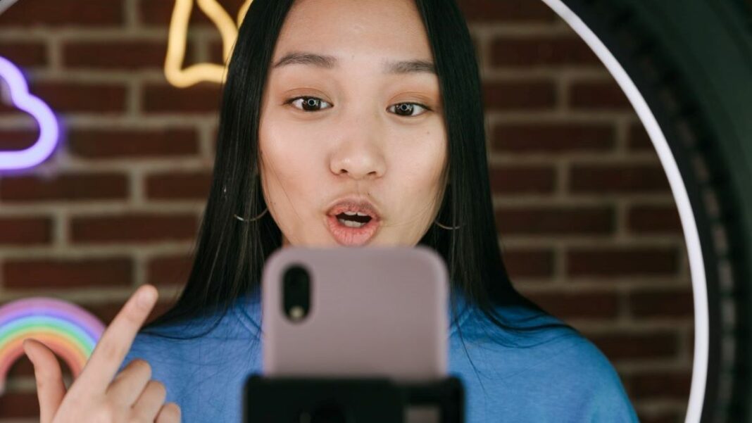 a micro-influencer recording herself on a smartphone