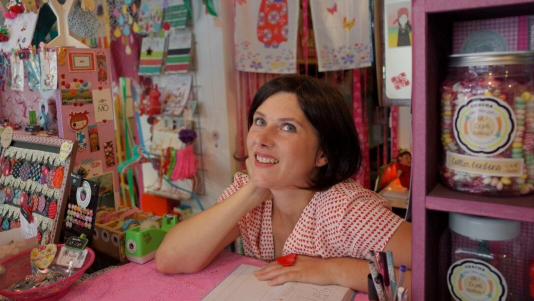 owner of a small-scale business in her colorful shop