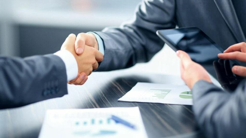 Refinance of a bad credit loan represented by people in business suits shaking hands
