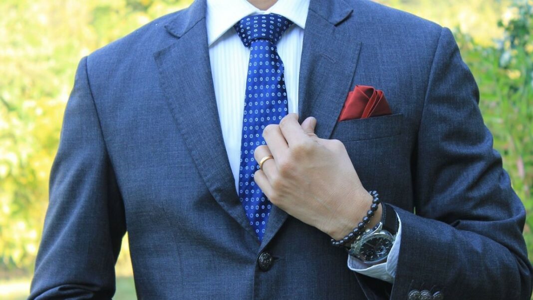 colors represented by a man wearing a blue suit with blue tie, white shirt, and red pocket square
