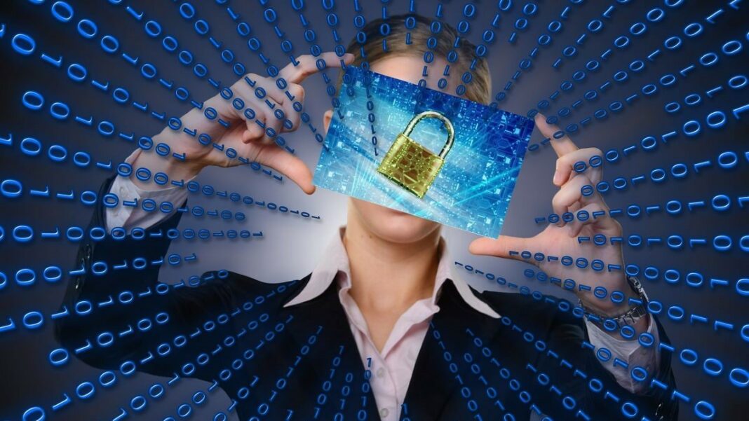 data breaches represented by an abstract image of a person in the center of a matrix of binary numbers holding up a data card with a picture of an old-fashioned padlock on it