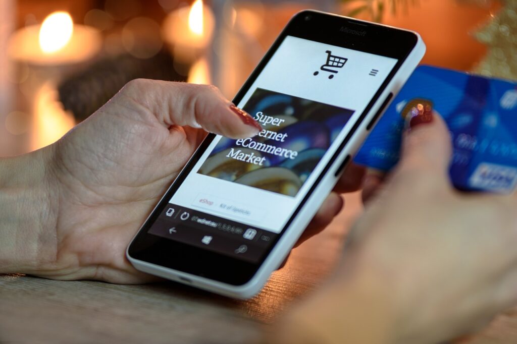Smartphone being used to make a purchase with a traditional credit card
