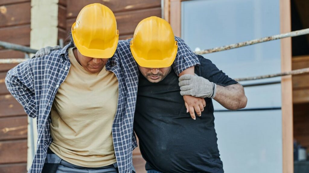 injured on the job represented by a worker supporting a coworker after an injury
