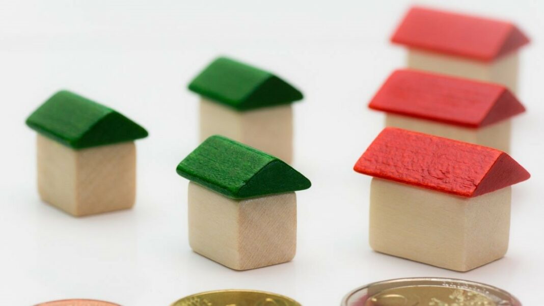 mortgage deal represented by toy houses and coins