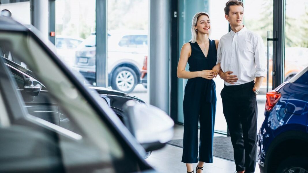 professional cleaners represented by a young couple choosing a car in an automobile showroom