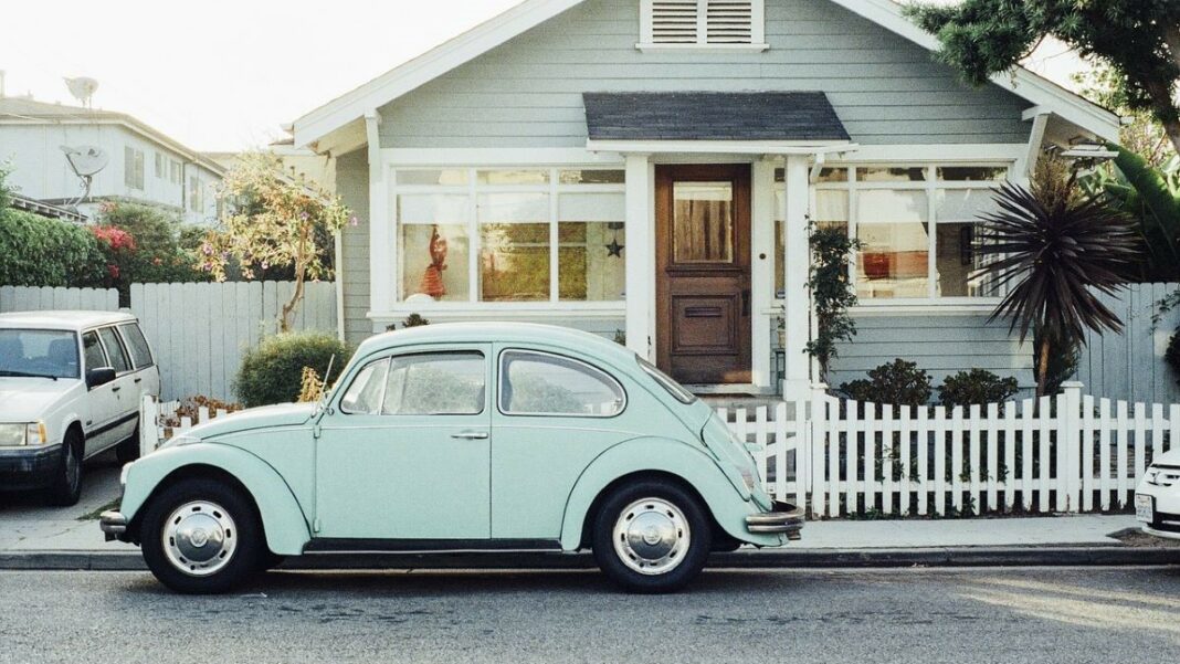 real estate market represented by a Beetle sitting in front of a small cottage