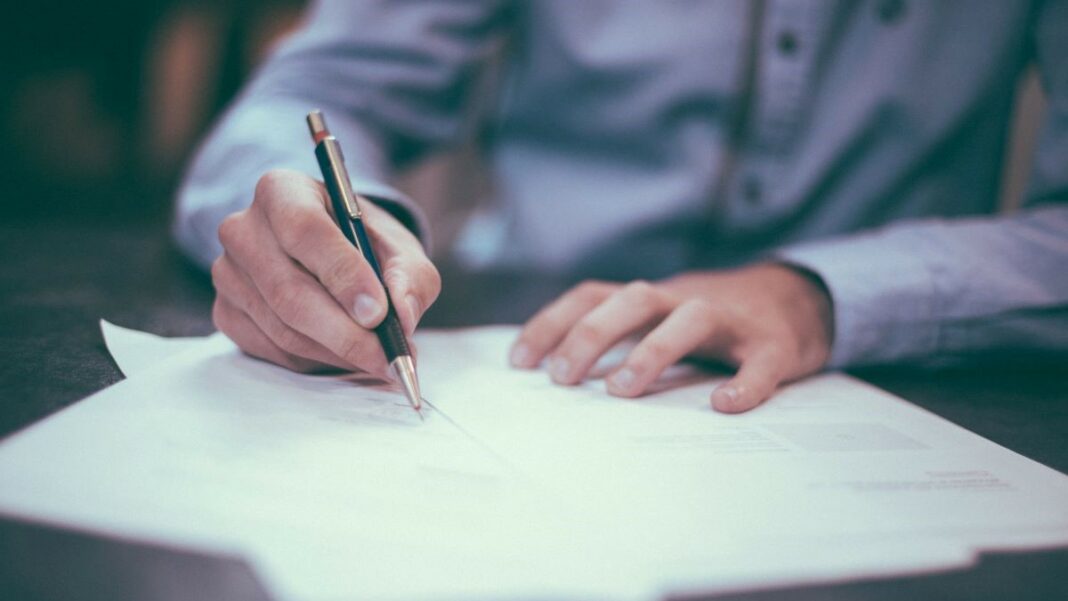 reverse mortgage represented by a man signing a contract