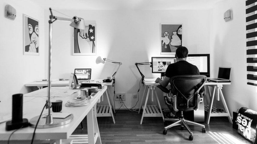 running a home business represented by a black-and-white photo of a business owner working from his home