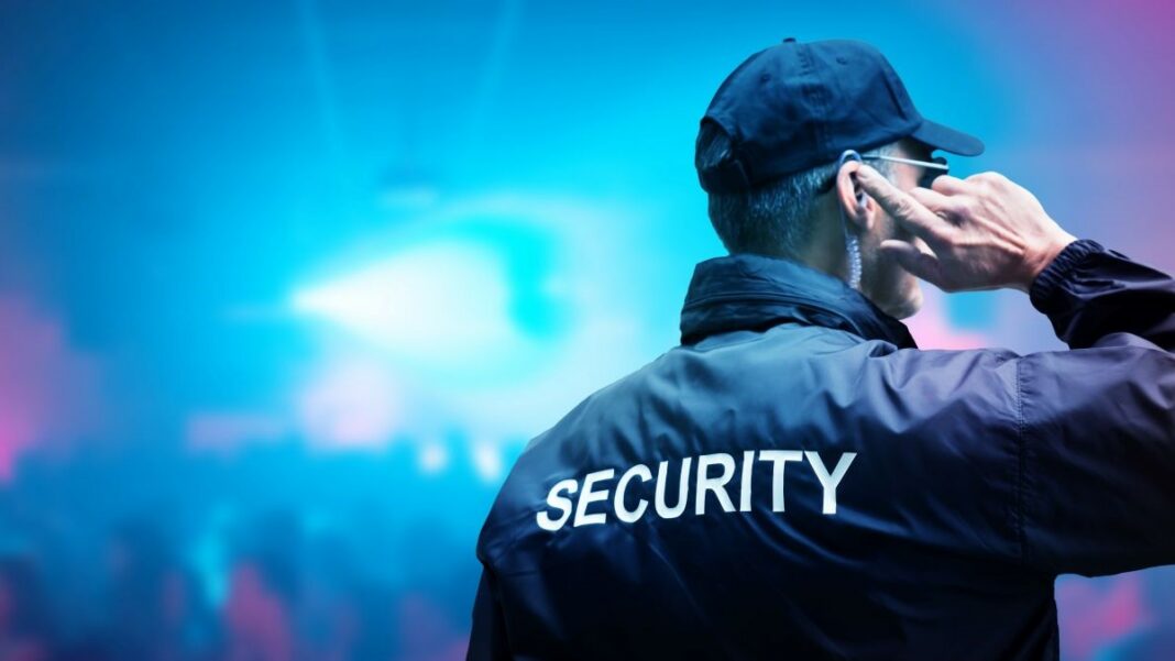security measures represented by a security guard at a nighttime concert or other event