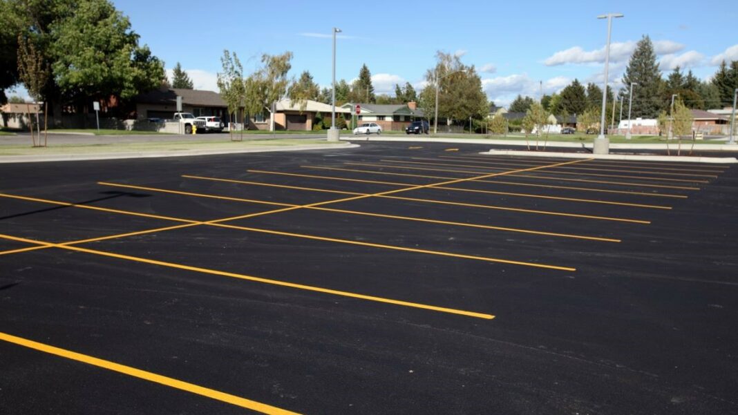 an asphalt parking lot freshly sealcoated and painted