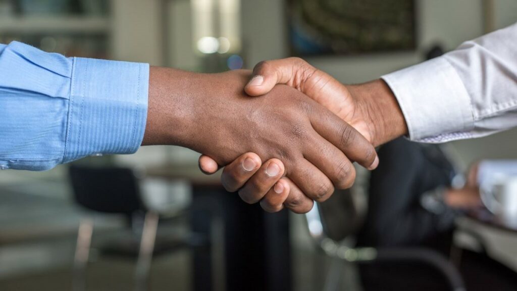 hiring new talent represented by a handshake between two men