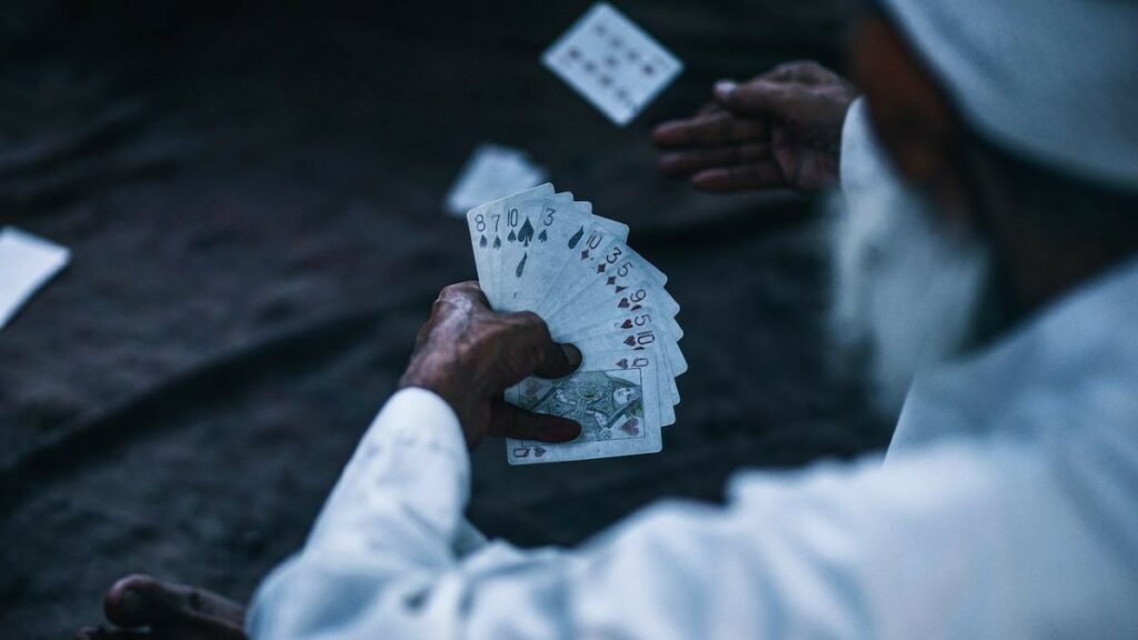 high RTP scores and Indian casinos represented by a man dressed in traditional Indian clothing playing cards