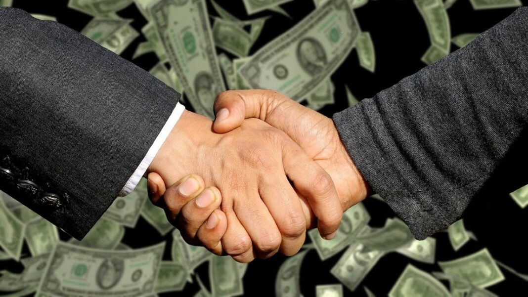 sales outsourcing represented by a handshake between two businessmen
