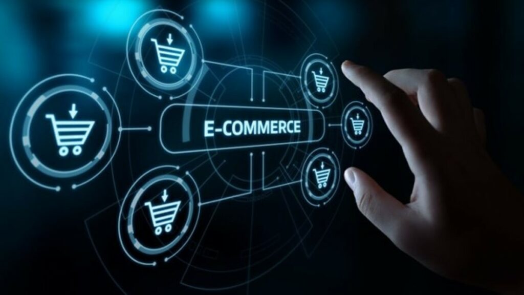 ecommerce operations represented by a hand hovering over a large touchscreen that shows a search bar containing the word "ecommerce" surrounded by shopping cart icons