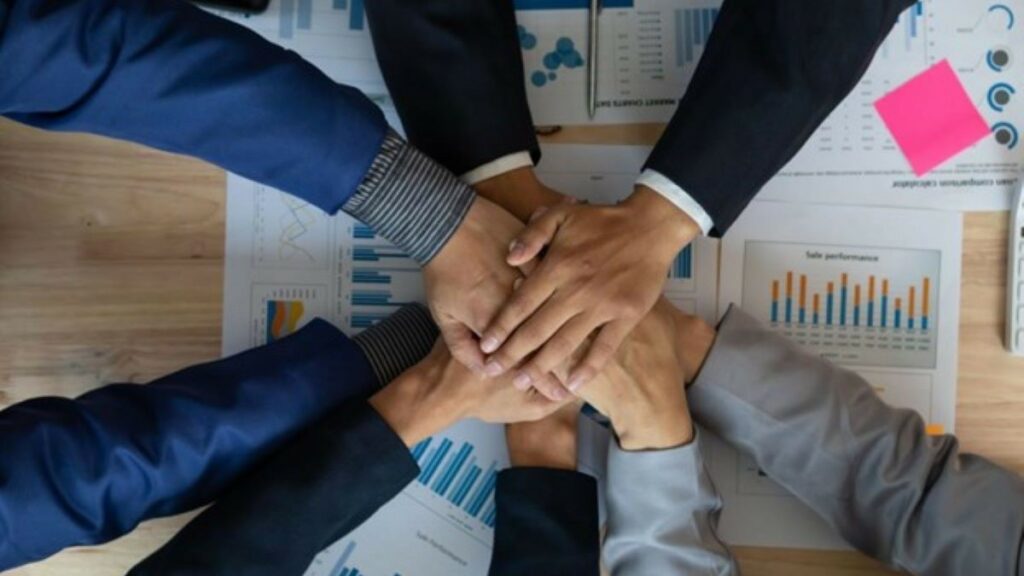 a high-performance team represented by businesspeople's hands in a team handshake