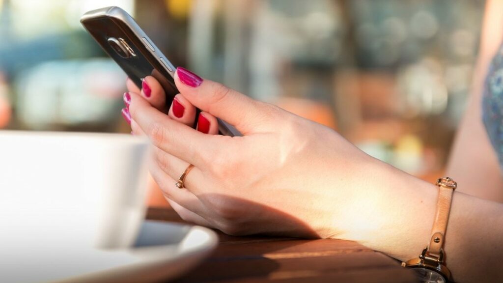 business communication represented by a woman's hands holding a smartphone