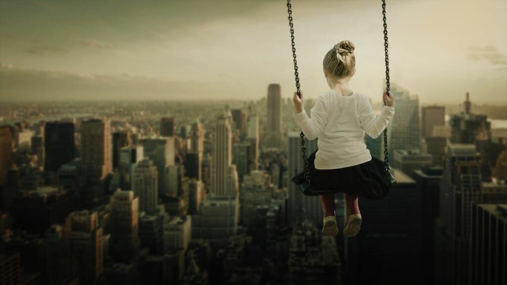 commercial property saftey represented by a young girl swinging above a city skyline