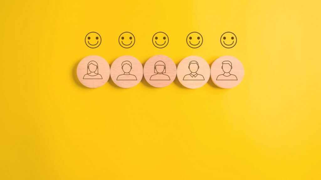 sentiment analysis represented by happy face emoticons on a yellow background