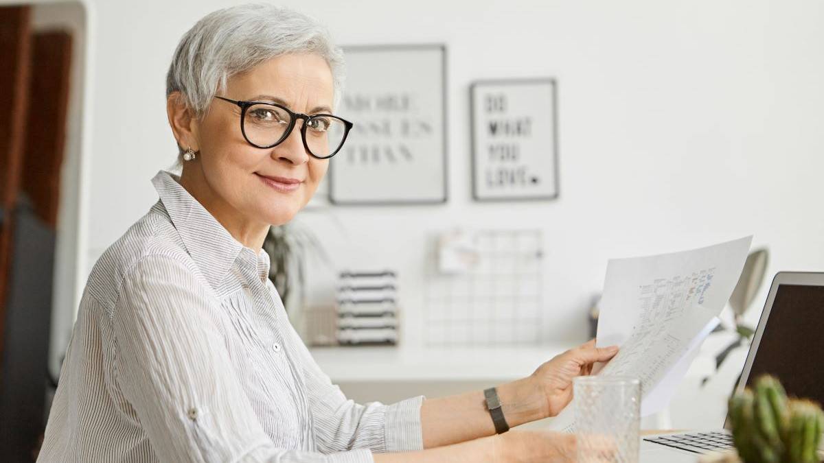 unretirement represented by a photo of a successful mature businesswoman working in her office