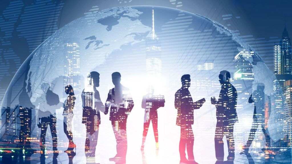 Venture capital represented by a toned image of business team members standing over night city background with double exposure of planet. Elements of this image furnished by NASA.
