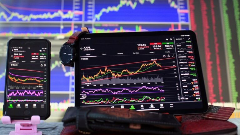 live updates represented by stock market feeds on both a smartphone screen and a computer screen